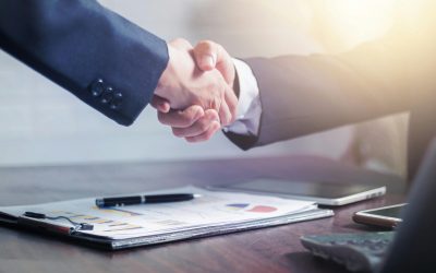 pexels-photo-4175028-4175028-3 Professional handshake agreement over business charts in an office setting.